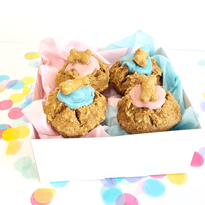 doggie cupcakes pupcakes in a mix of blue and pinkcarob toppings  each with a handmade bone treat on top