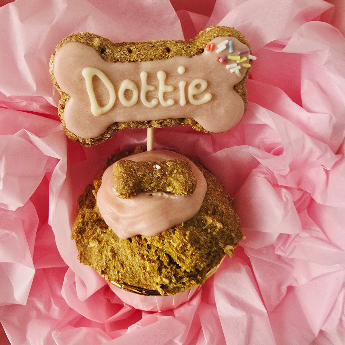 Dog pupcake cupcake personalised with dogs name on a bone shapred dog treat in pink ,names dottie 